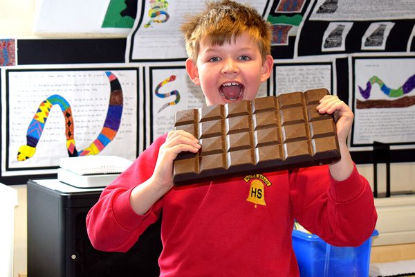 boy-holding-large-bar-of-chocolate