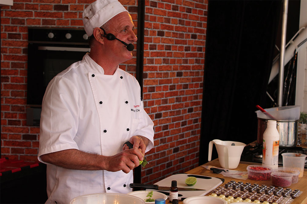 Carl Turner doing a chocolate making demonstration on stage