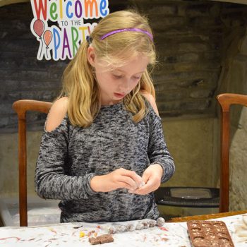 Young girl making chocolate truffles