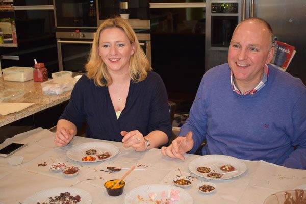 Man and woman making chocolates